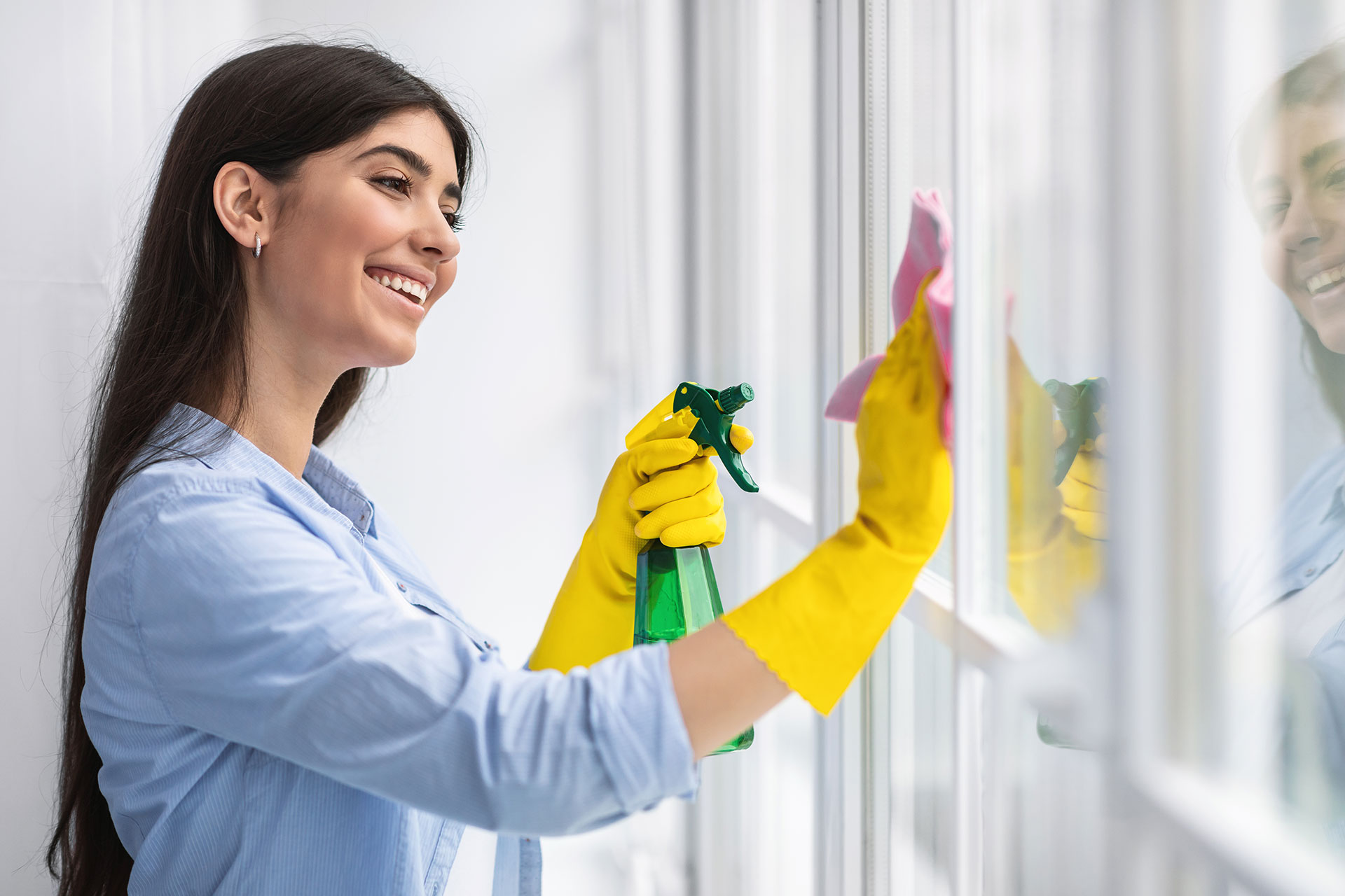 woman-cleaning-window-with-rag-and-cleanser-spray-2021-09-03-14-19-50-utc.jpg